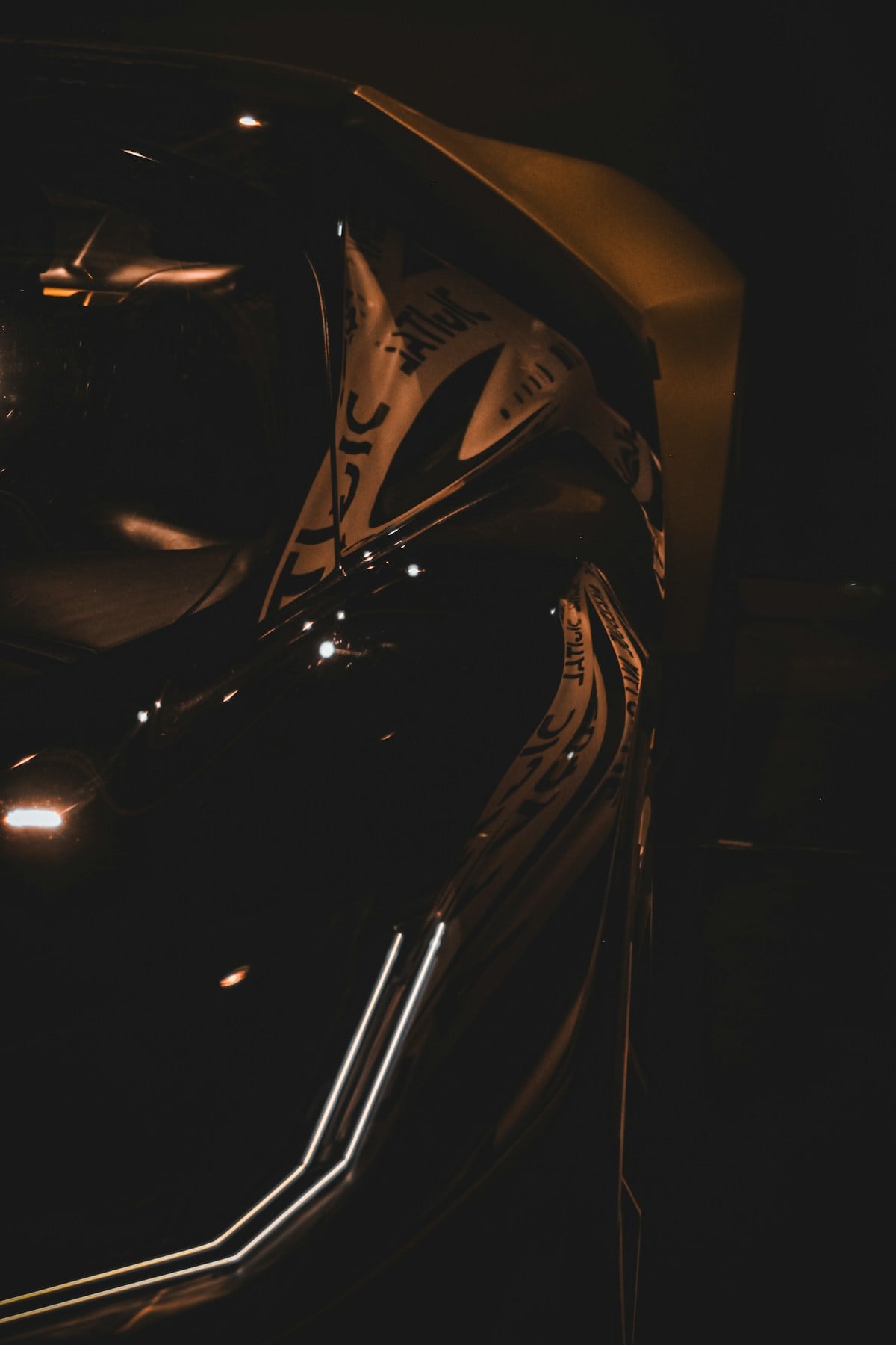 A freshly detailed black car under studio light